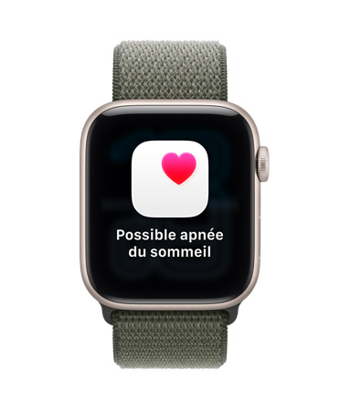 Apple Watch SE 3, boîtier en aluminium, comète, notification de possible apnée du sommeil, cœur rose dans un encadré blanc, côté droit, couronne Digital Crown, bracelet sport à rabat, forêt