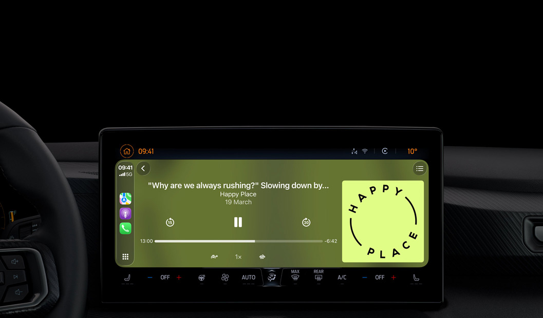 A car interior, centre console display shows Apple Podcasts playing via CarPlay, now playing “The Spark of Life” podcast by Radiolab, playback controls include skip back, pause and skip forward