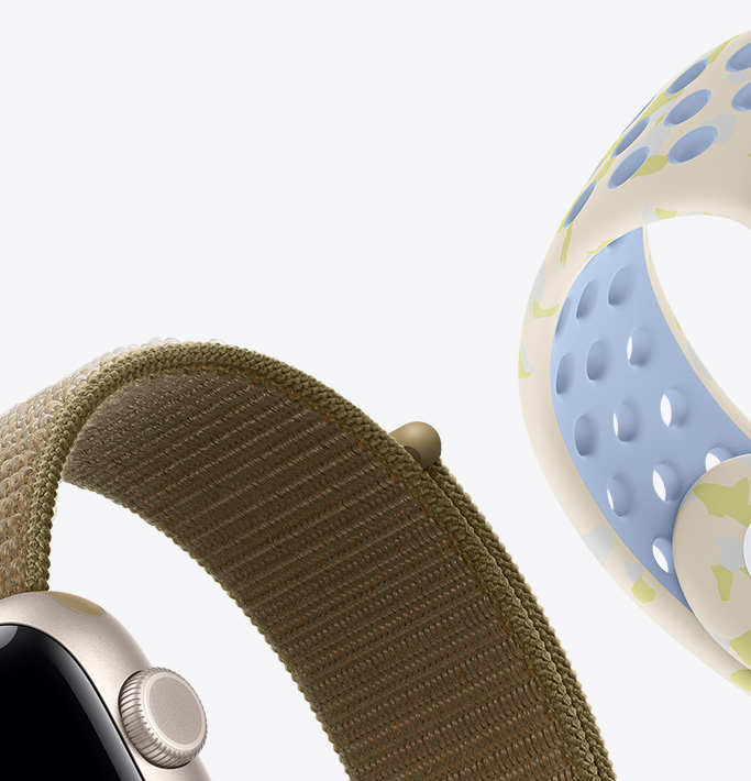 スターライトアルミニウムケースのApple Watch SE 3。オリーブ（アースカラーのグリーン）のスポーツループバンド、チョークカーム（外側はクリーム色、肌に触れる側は淡いブルー、黄緑色の図形による目立たない模様）のNikeスポーツバンド