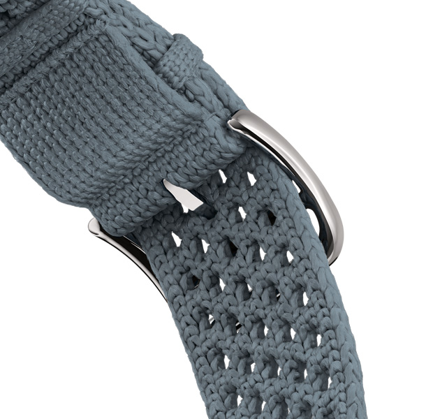 Apple Watch Hermès Series 11 con correa Néo Tricot, color Bleu Gris (gris azulado), fabricada con hilo de poliamida tejido, orificios de ajuste en el centro, hebilla color plata
