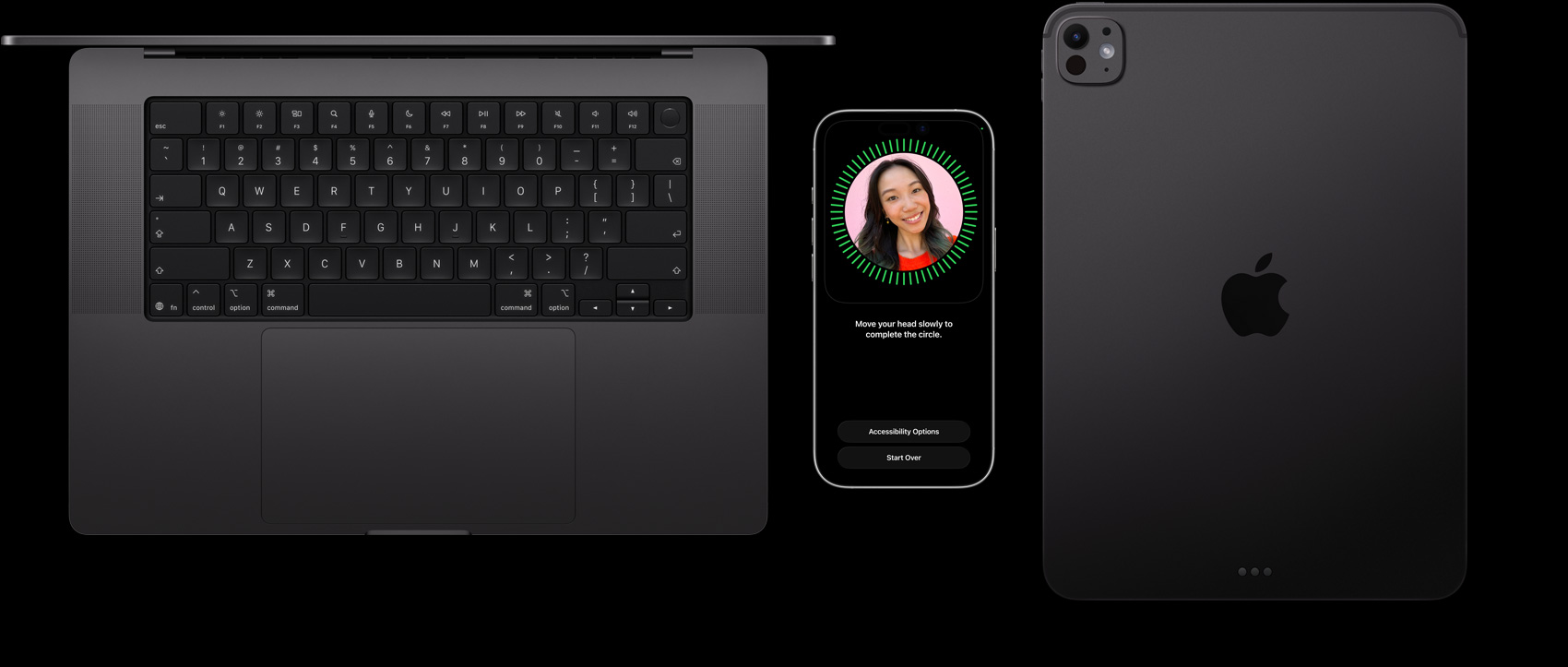 A MacBook in Space Black, an iPhone in Natural Titanium, and an iPad in Space Black sit side-by-side with a Face ID setup displayed on the iPhone