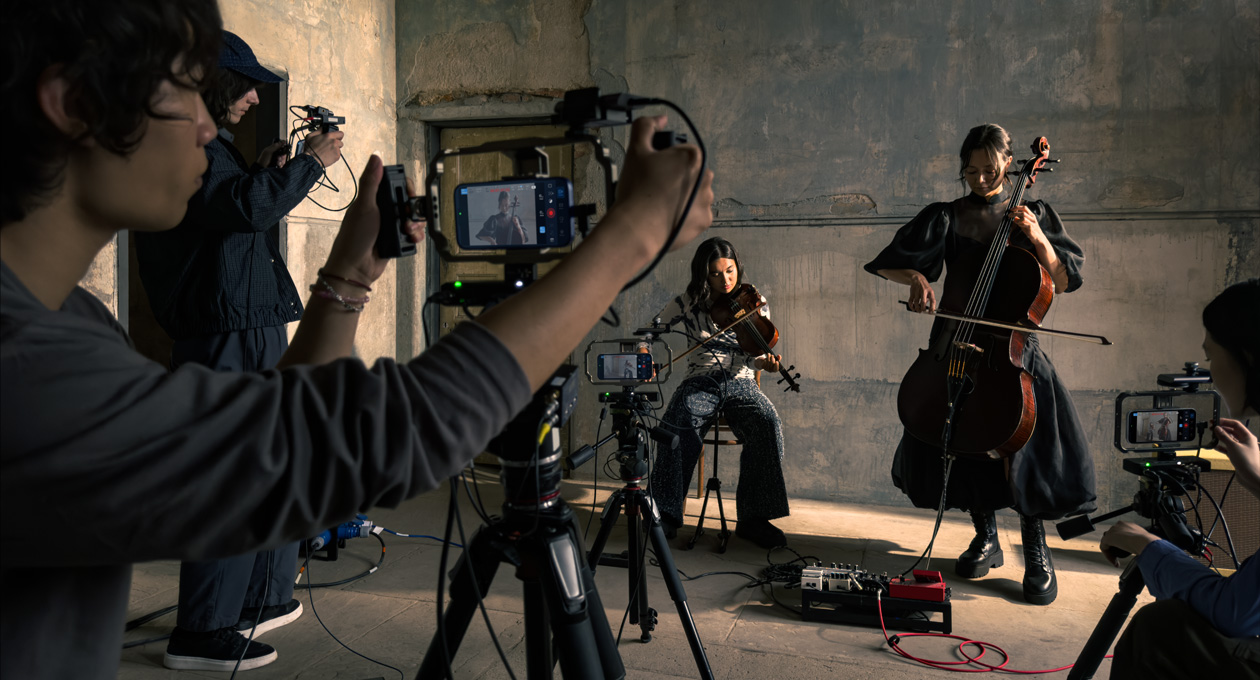 iPhone 17 Pro sits on a tripod showing the genlock and timecode support feature while recording during a film shoot